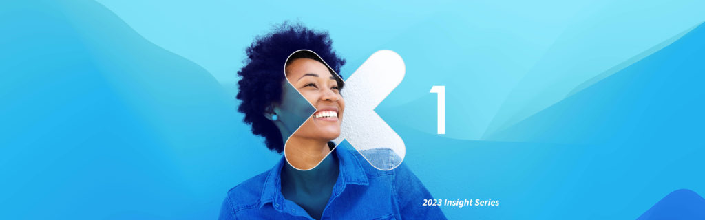 Smiling woman in front of bright blue background.